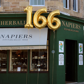 Napiers historic storefront with large gold 166 balloons celebrating 166 years, Edinburgh 1860