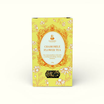 Napiers Chamomile Flower Tea 100g box with bright yellow packaging, ornate gold frame, and loose chamomile flowers visible through window