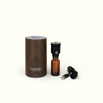 Napiers Waterless Nebuliser Aroma Diffuser displayed with amber glass bottle and USB cable
