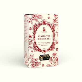 Napiers Wintertime Booster Tea box angled view showing cream packaging with red floral pattern and product details